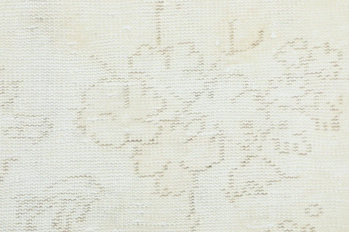 Extreme close-up of the low wool pile, showing the hand-knotted texture and subtle color variations.