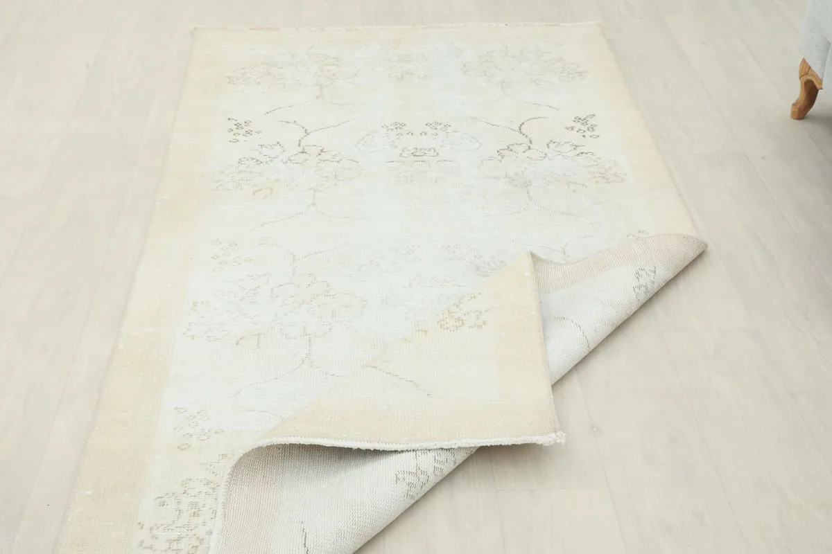 The rug partially folded, demonstrating its flexibility and the uniform backing.