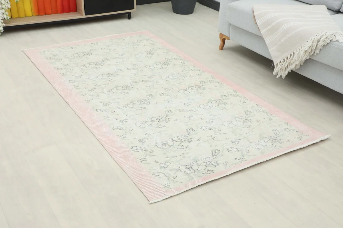 Overhead view of the vintage rug in a living room, showcasing its placement relative to furniture.