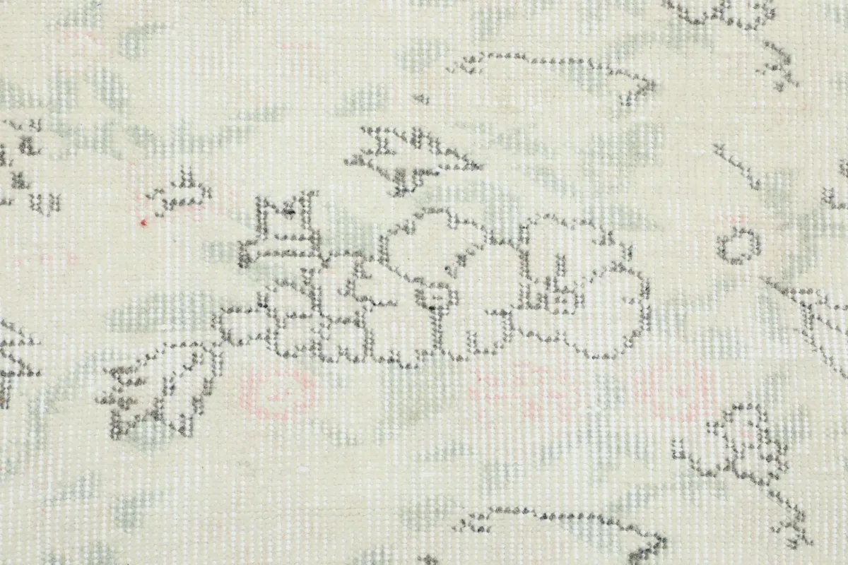 Extreme close-up of the hand-knotted wool pile, revealing individual knots and faded patterns.