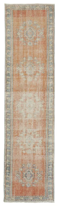 Full overhead view of the rust and blue geometric vintage Anatolian runner rug on a white background.