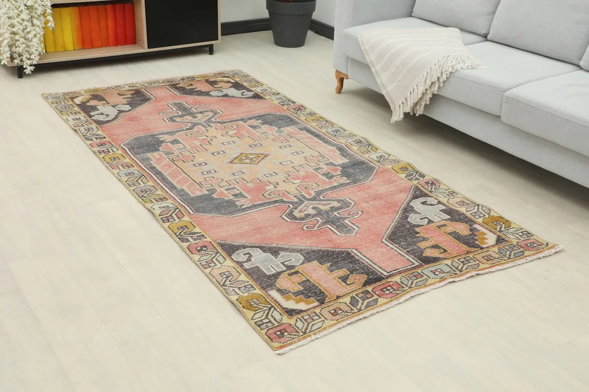 Medium area rug showcasing its rose and charcoal colors in a modern living space