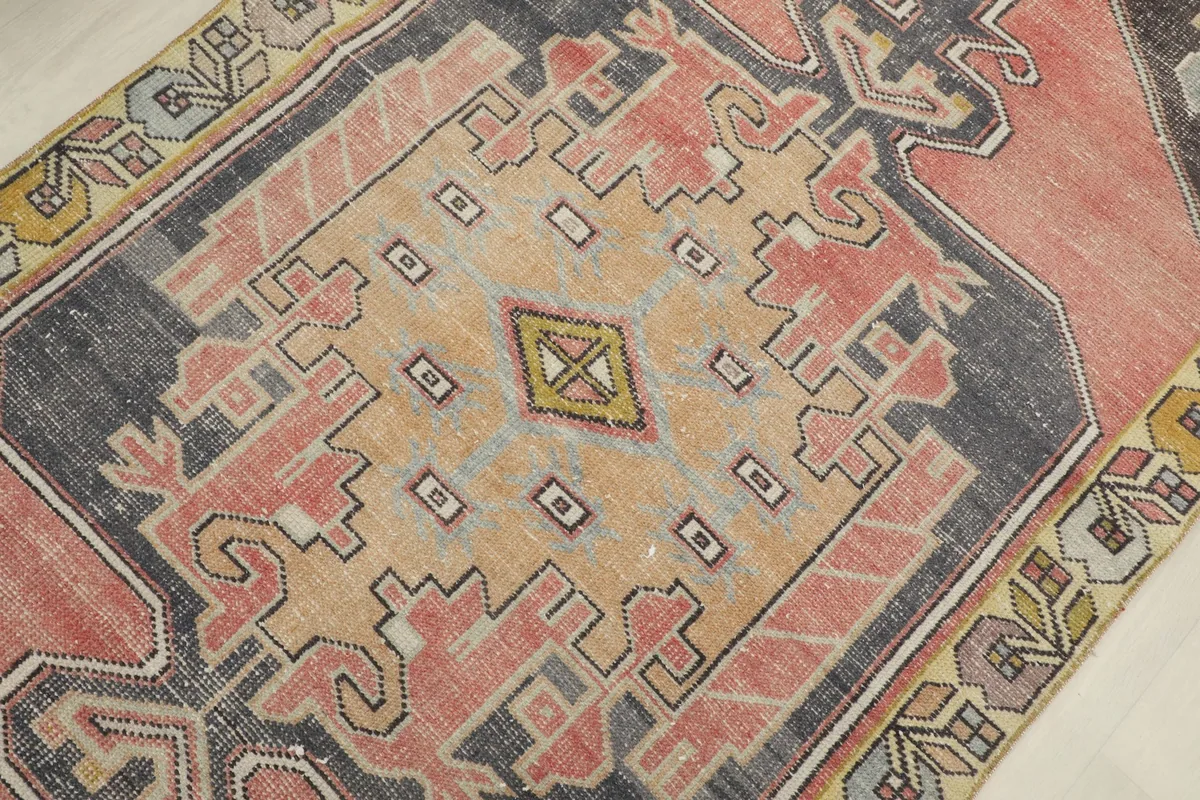 Detailed view of the central medallion design on the vintage wool rug