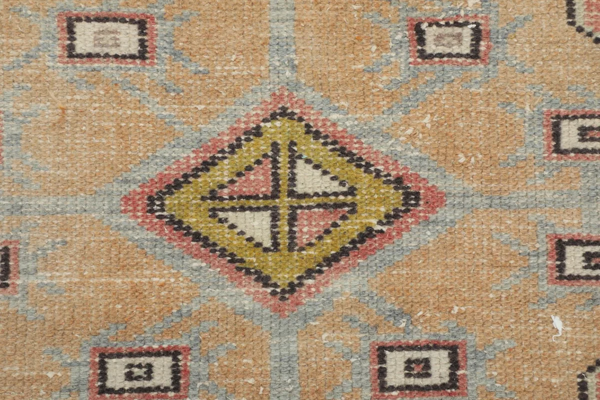 Close-up of the central diamond motif within the medallion, showing texture and color
