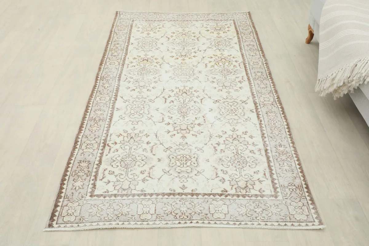 Full overhead view of the ivory and beige vintage rug in a room setting