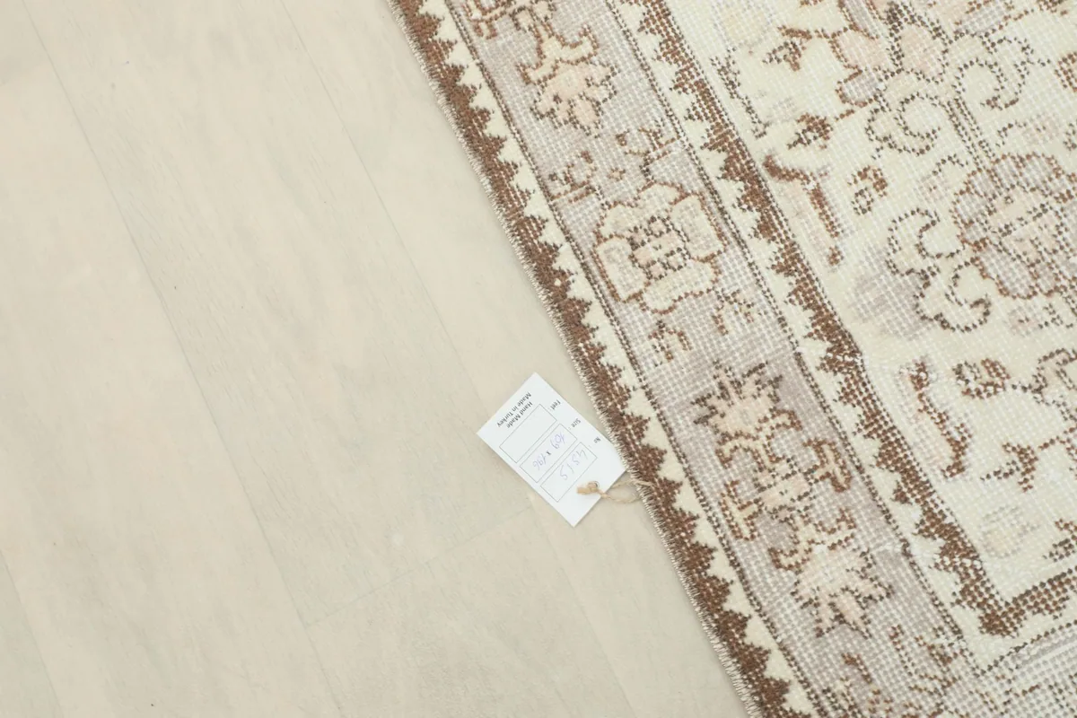 Close-up of a care tag near the border of the professionally cleaned rug