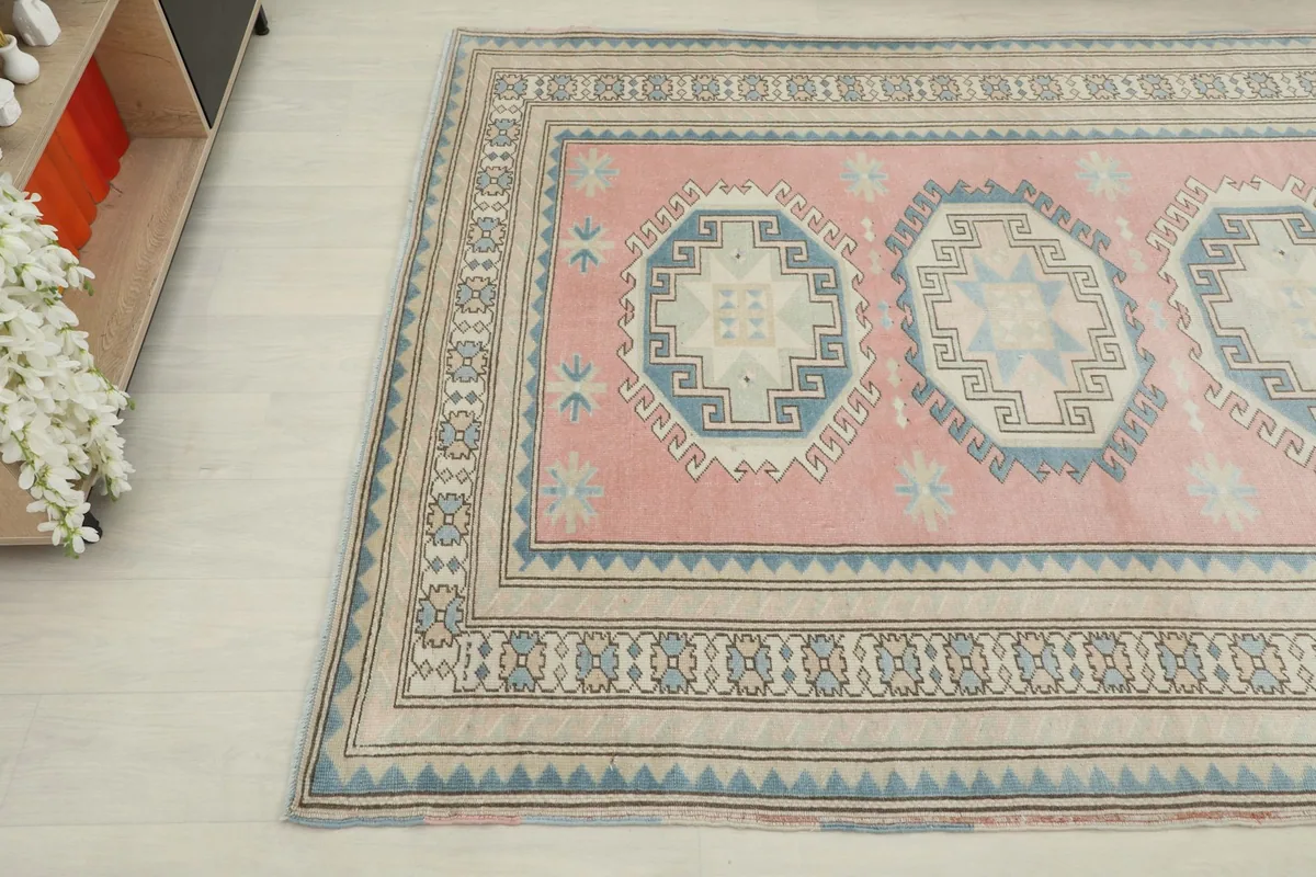 Overhead angle shot of the rug showing a corner, border, and central medallion details