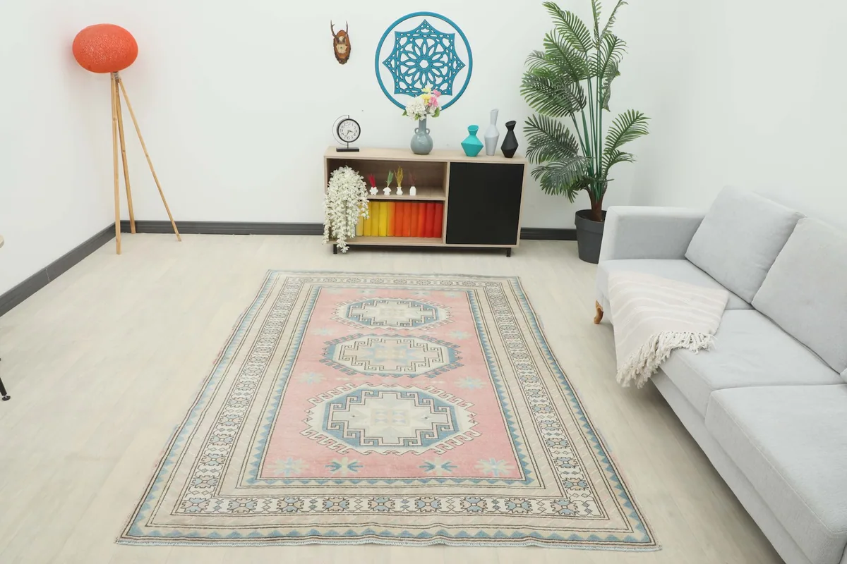 Full room view with the pink Anatolian rug as a central feature, showing furniture and decor