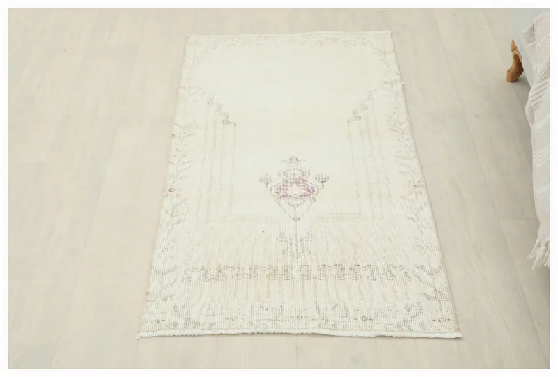 Full top view of the 2'3" x 4'0" vintage Anatolian rug with ivory field and rose motif