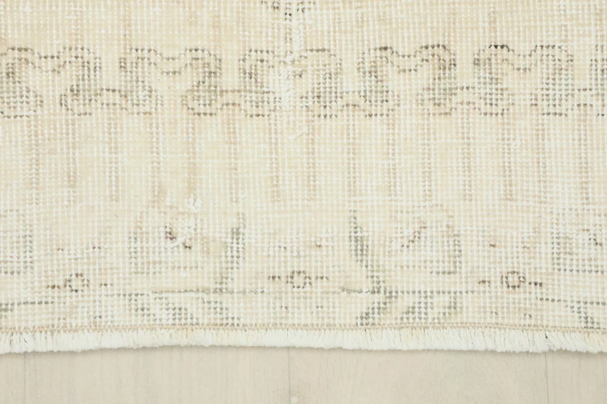 Close-up of the rug's bottom edge and fringe, showcasing the low pile and border design
