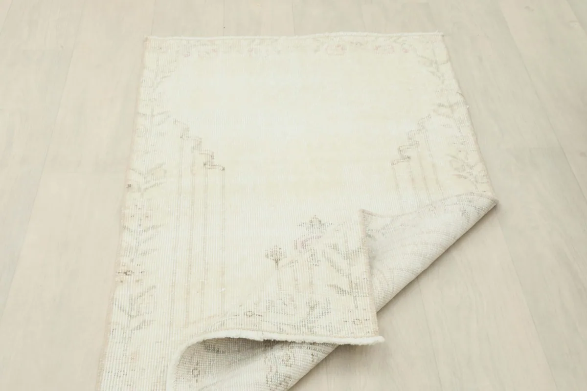 Rug partially folded, illustrating its flexibility and thin profile