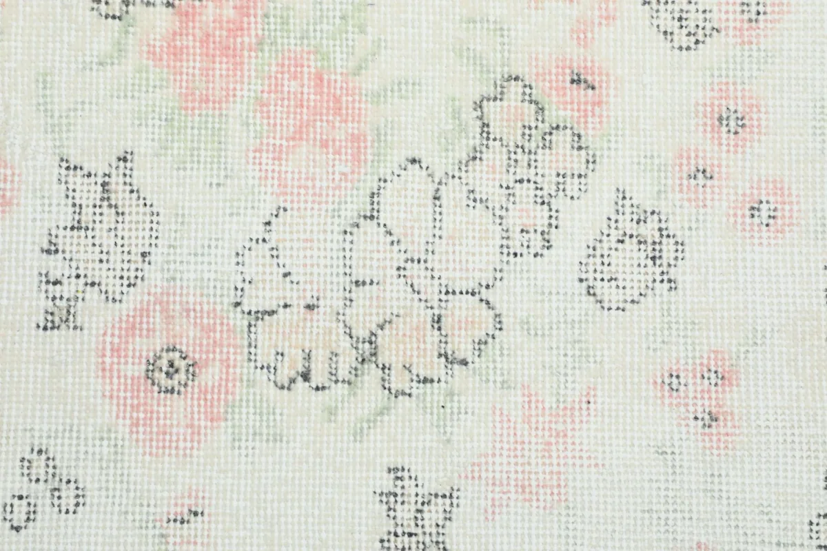 Close-up of the low pile and hand-knotted texture, revealing the intricate floral details and colors
