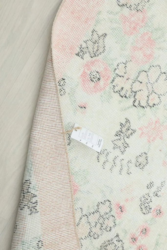 Close-up of the rug's label attached to the underside, showing product information