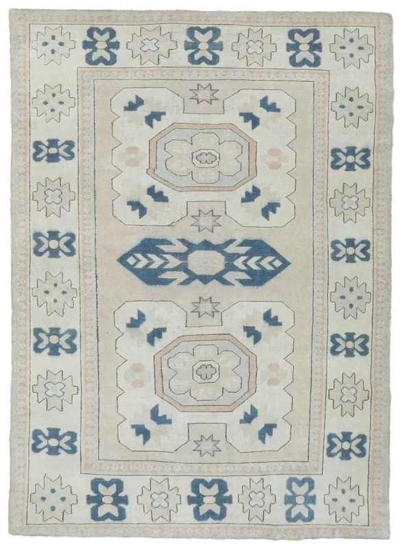 Full overhead view of the beige and blue geometric tribal vintage Anatolian rug
