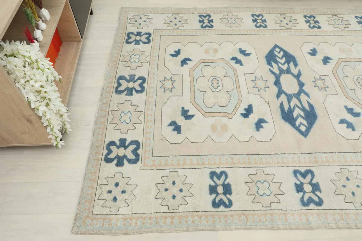 Detailed angle showing the rug's central design elements and outer border patterns