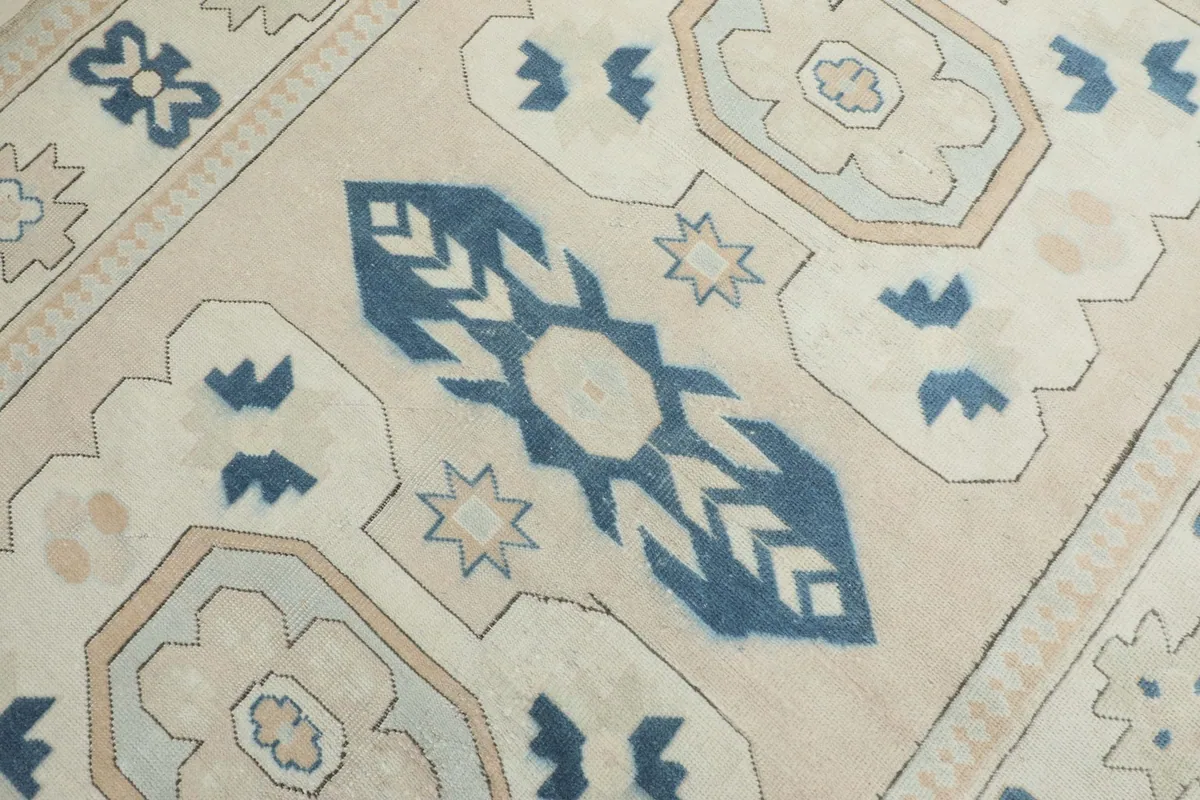 Close view of the central blue tribal motif and surrounding beige and tan geometric shapes