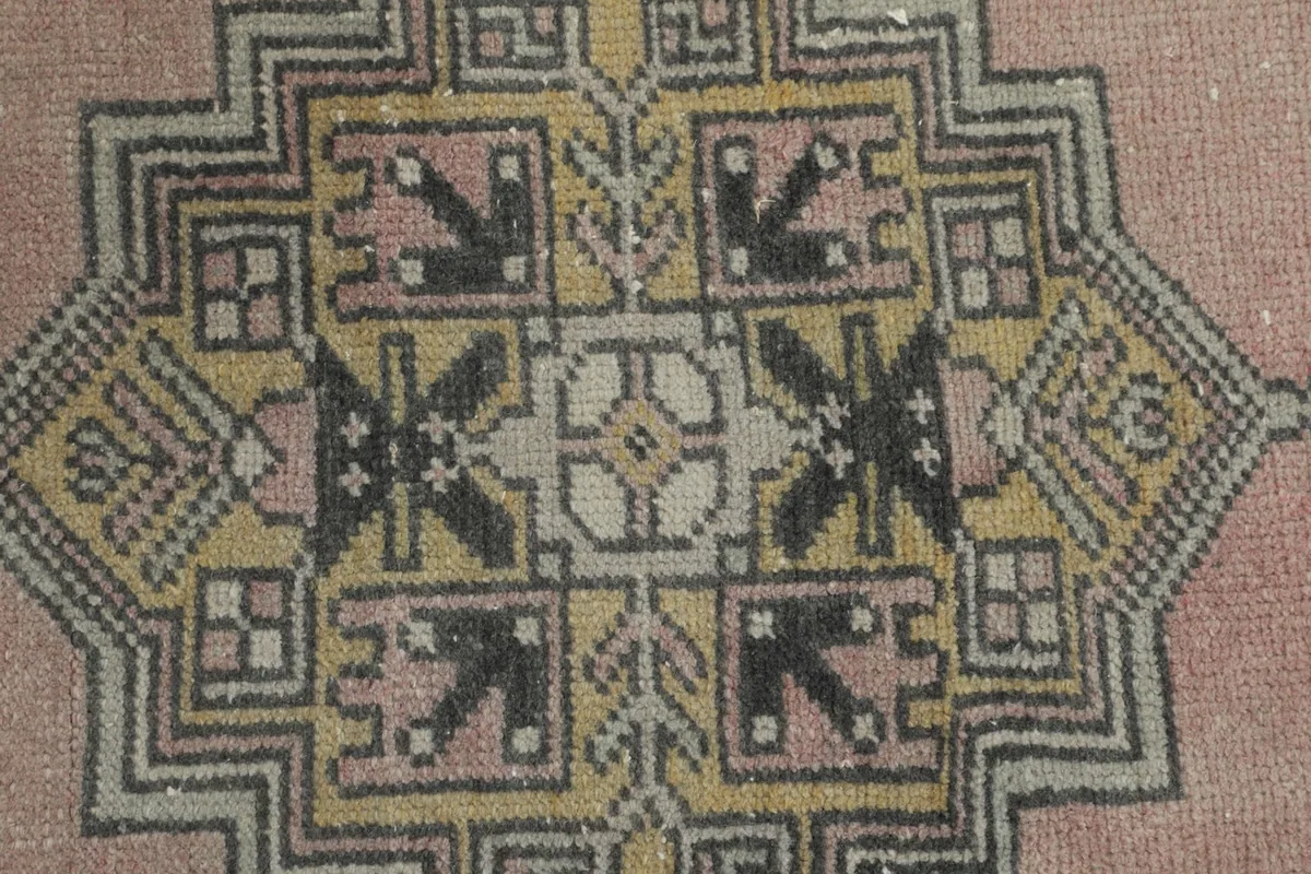 Close-up of the intricate geometric motifs within one of the rug's medallions