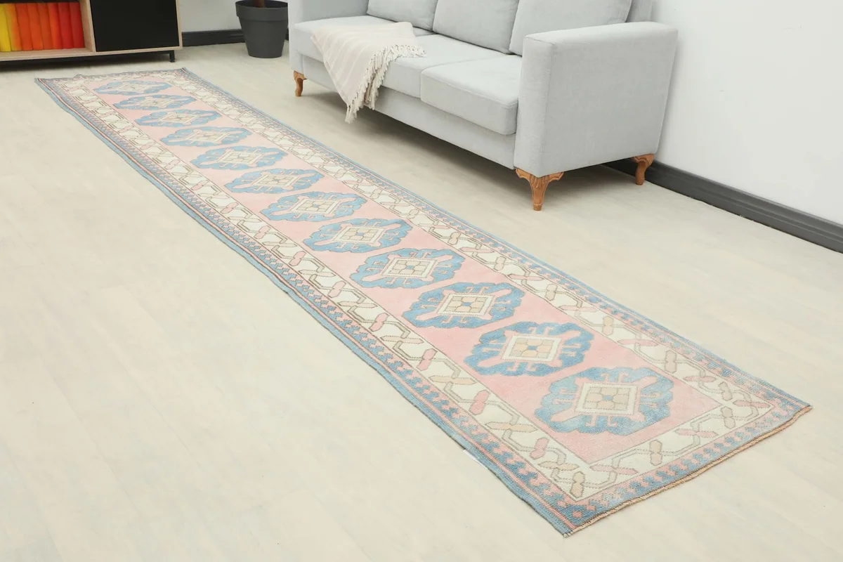 Angled view of the vintage Anatolian runner rug in a room, showing its length and how it complements the space.
