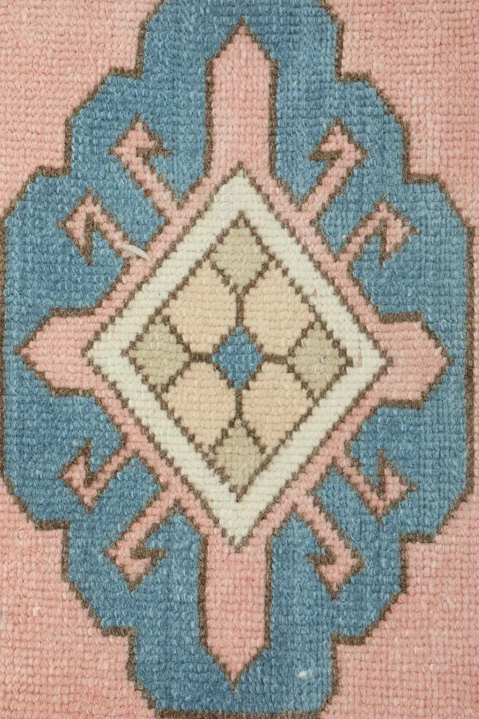 Close-up of a single blue geometric medallion, revealing the intricate patterns and color nuances within the design.