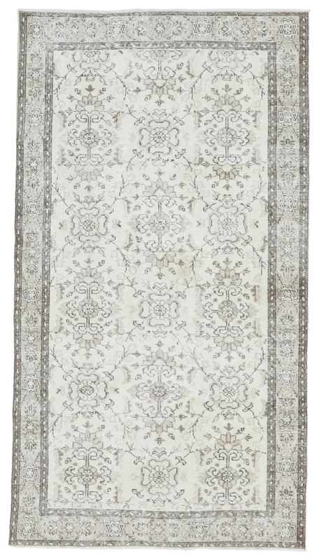 Full top view of the cream and gray floral vintage Anatolian rug