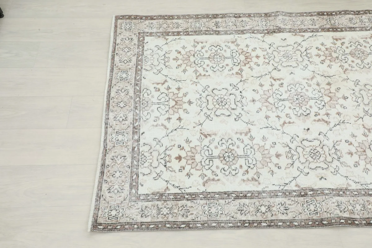 Close-up angled view of the rug's corner, highlighting the floral pattern and border