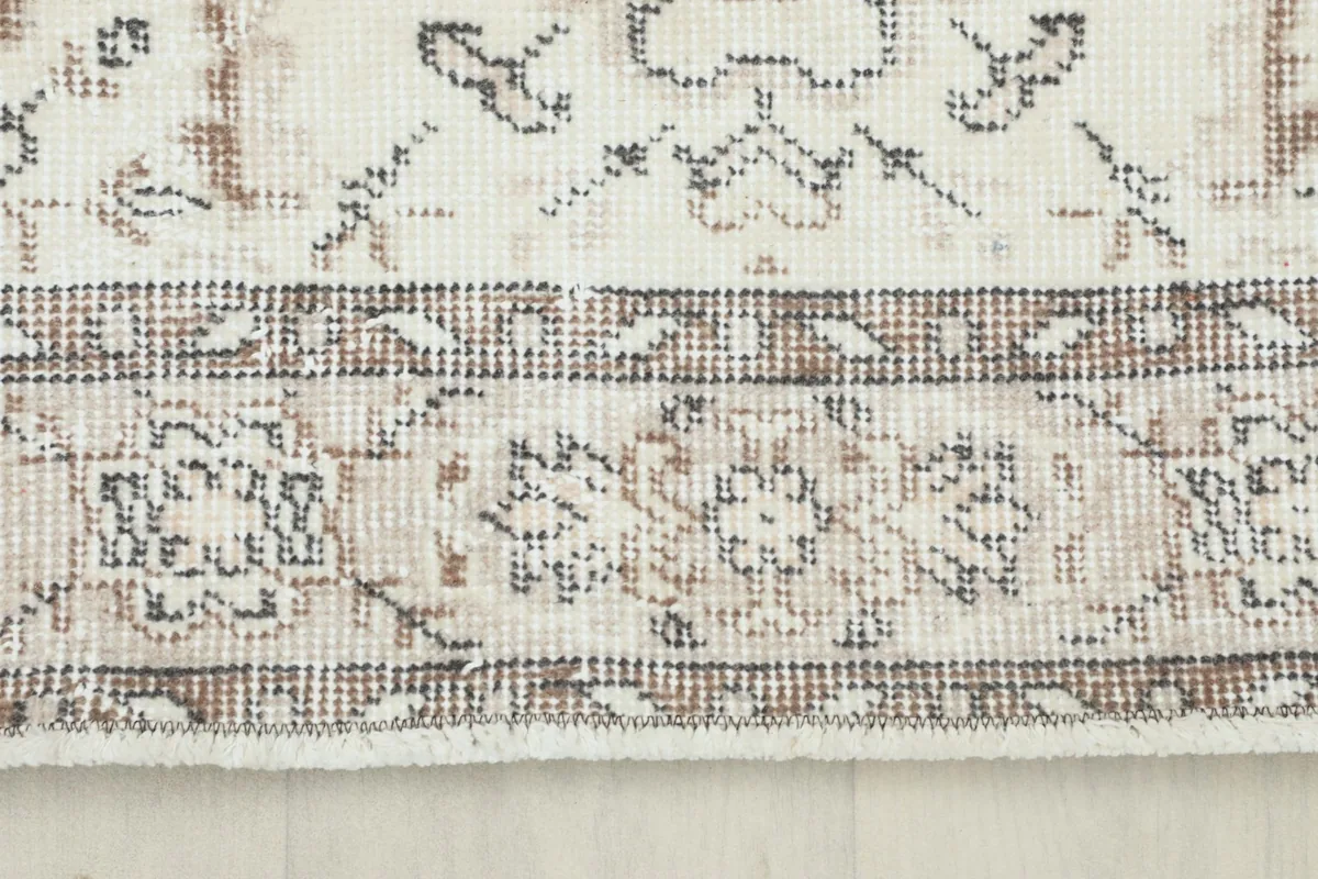 Close-up of the rug's border, showcasing its geometric and floral elements