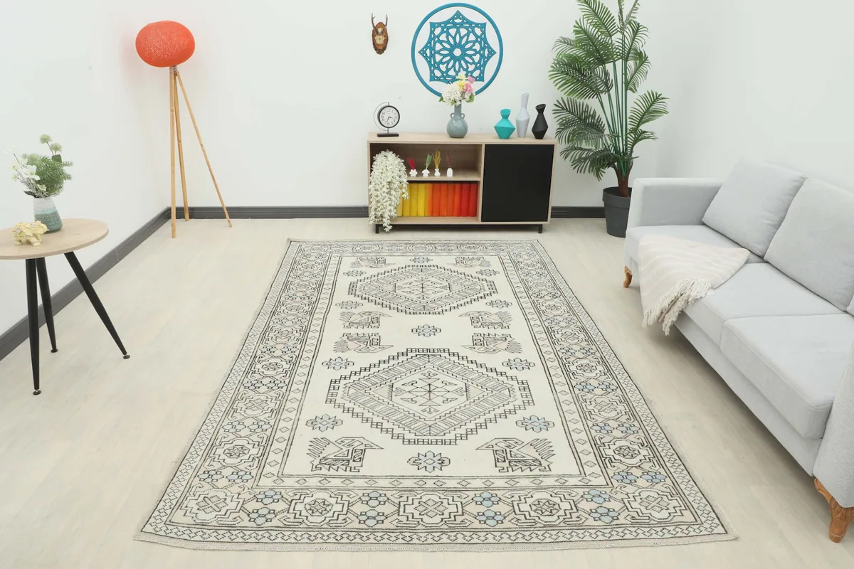 Full view of the vintage Anatolian rug in a contemporary living room, providing a sense of scale.