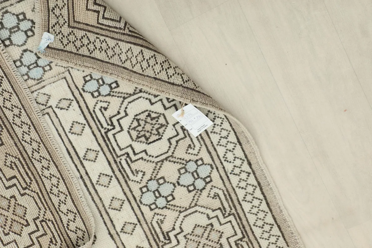 Underside view of the hand-knotted rug, revealing the cotton foundation and knotting structure.