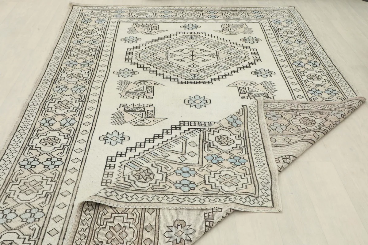 Rug partially folded, illustrating its flexibility and the consistent pattern across the surface.