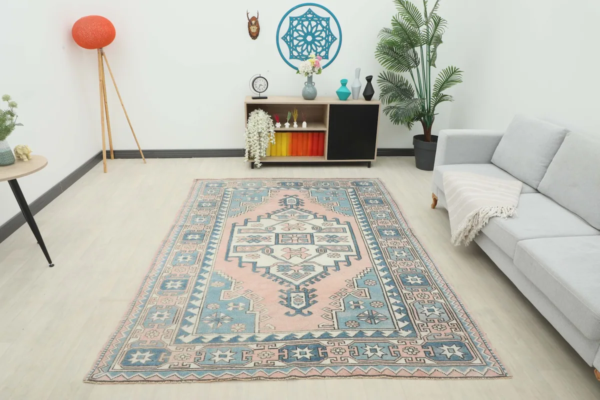 Wide shot of the 6x8 vintage rose and blue rug providing a focal point in a contemporary living space