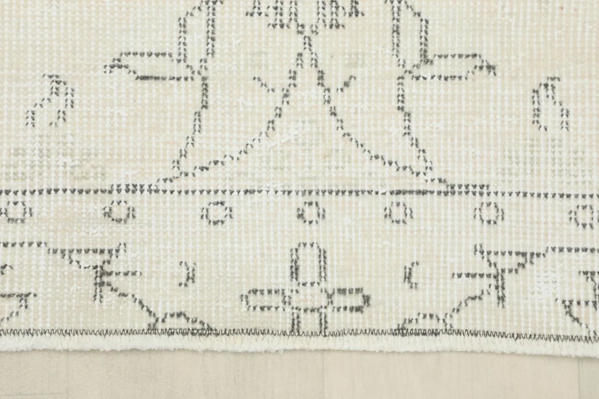 Close-up of the rug's border, displaying the distinct geometric patterns and edge finishing.