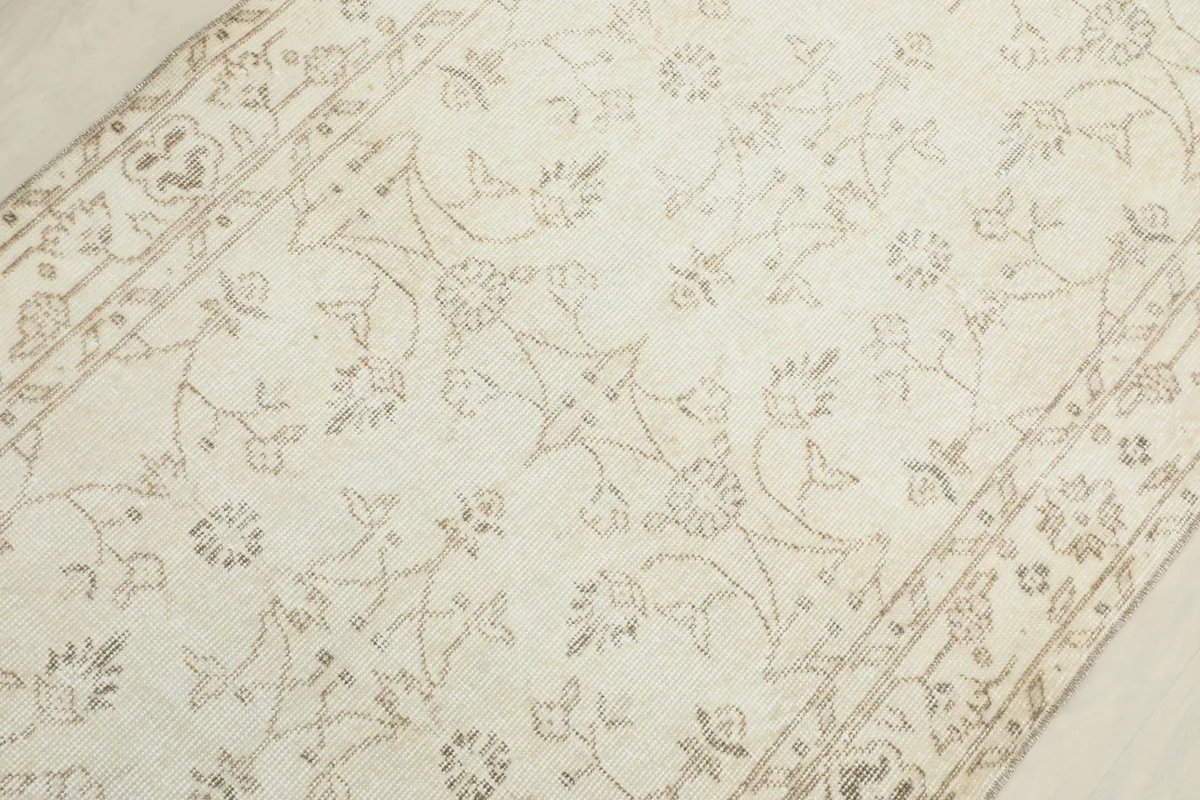 Detailed view of the central field of the Beige Subtle Floral Rug, showing faded patterns.