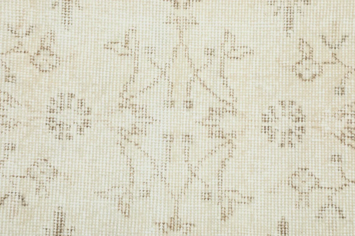 Very close view of the low pile and intricate knotting of the Beige Subtle Floral Rug.