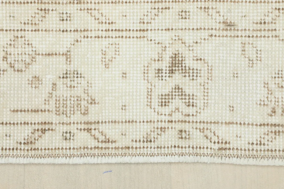 Detailed shot of the border design of the Beige Subtle Floral Rug, showing its distinct patterns.