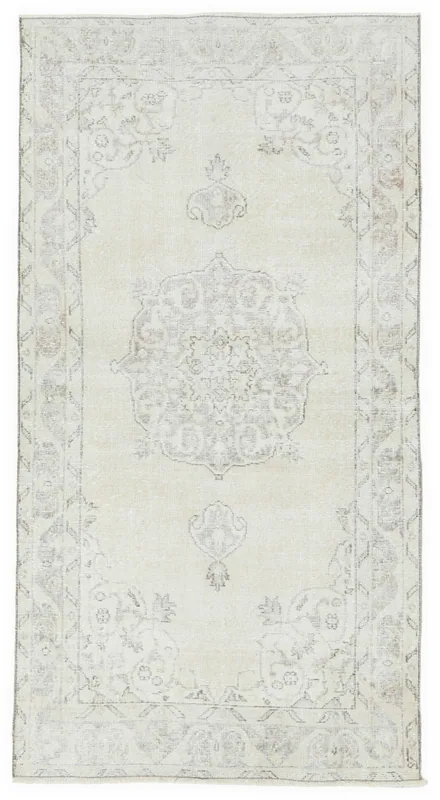 Full overhead view of the ivory and beige vintage Anatolian rug with a central medallion.
