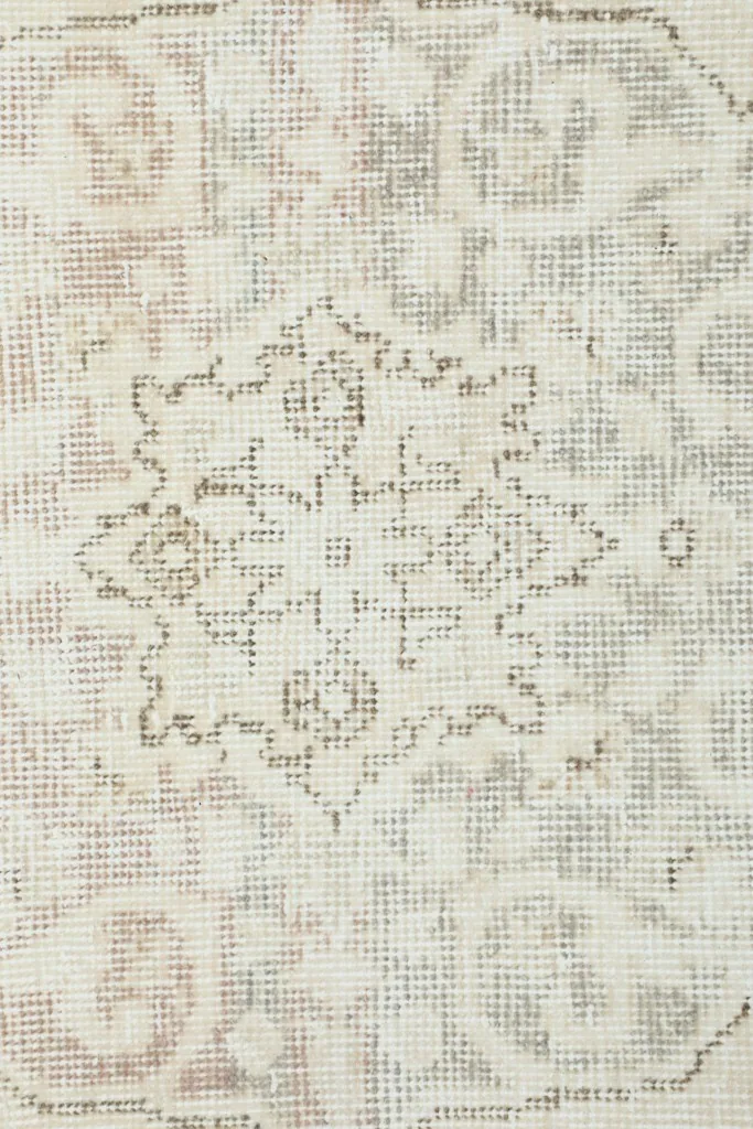 Texture detail of the low wool pile, showing the hand-knotted construction and vintage patina.