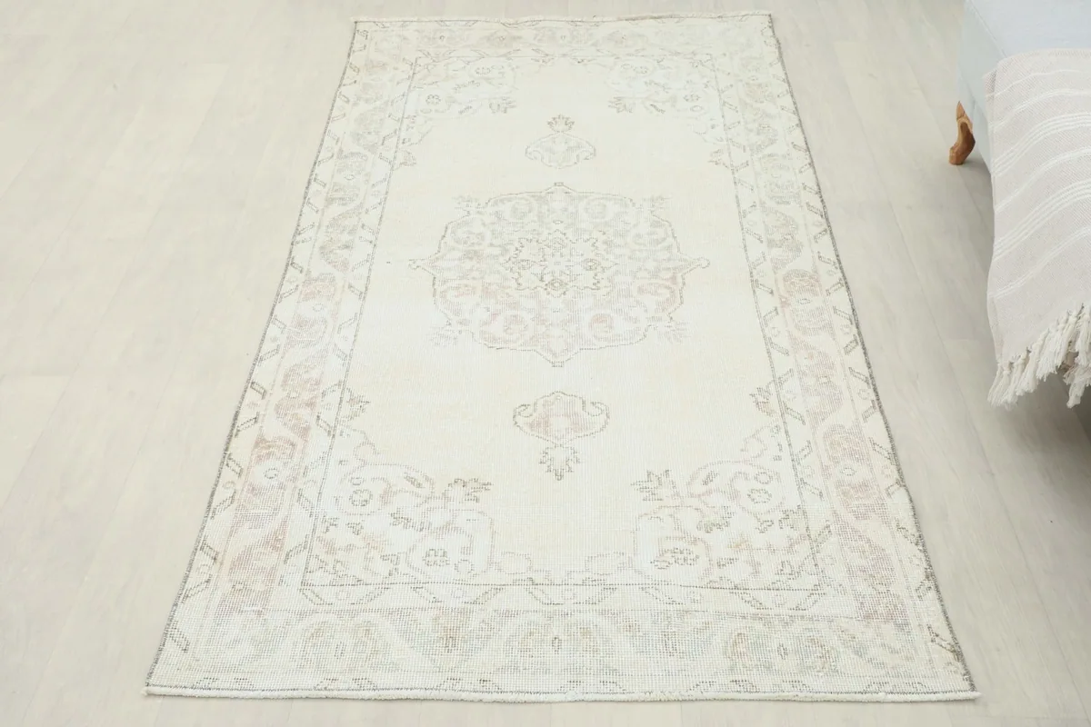 Full overhead view of the ivory vintage rug on light flooring, from a slightly elevated perspective.