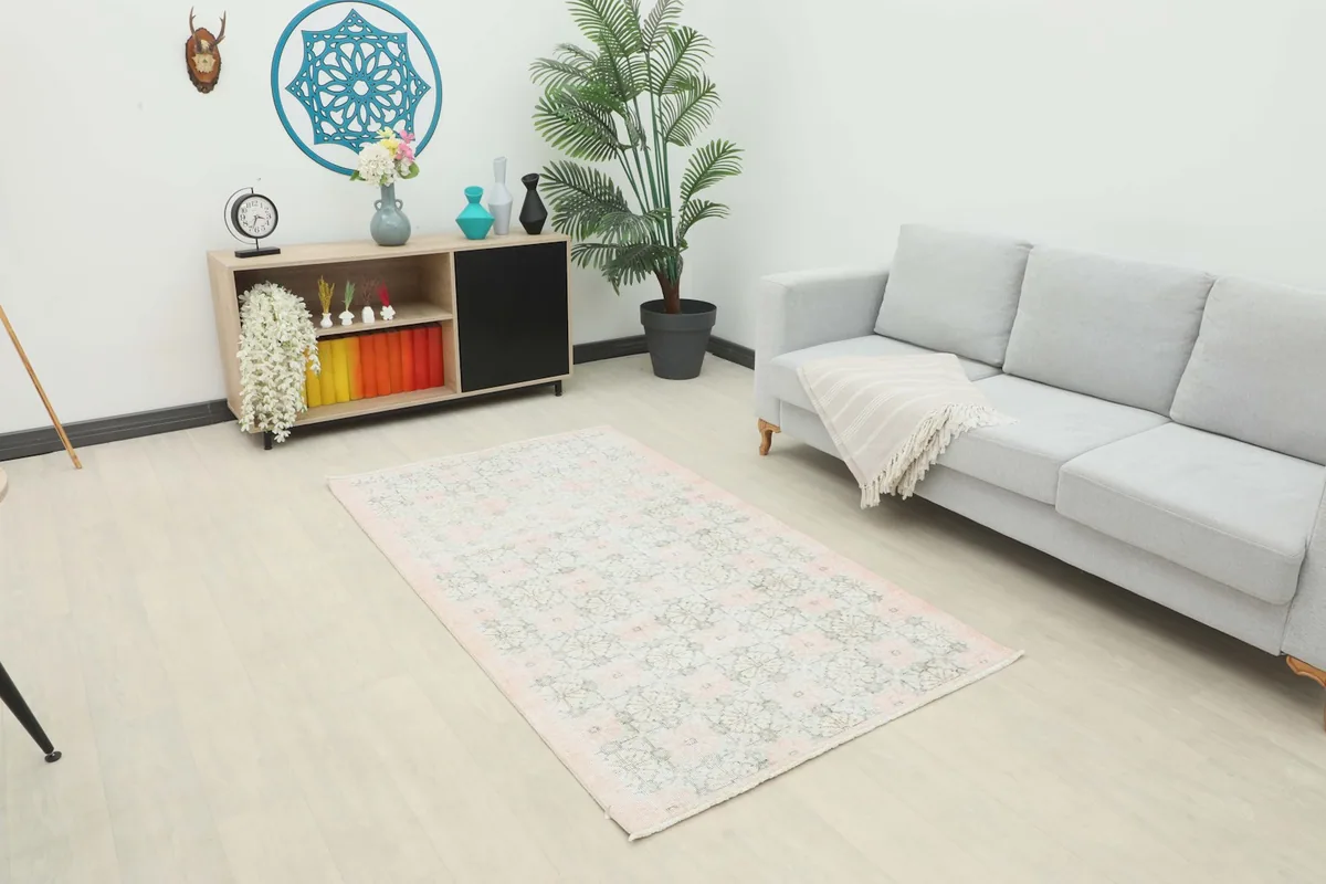 Vintage Anatolian rug displayed in a living room setting, showing its size relative to furniture