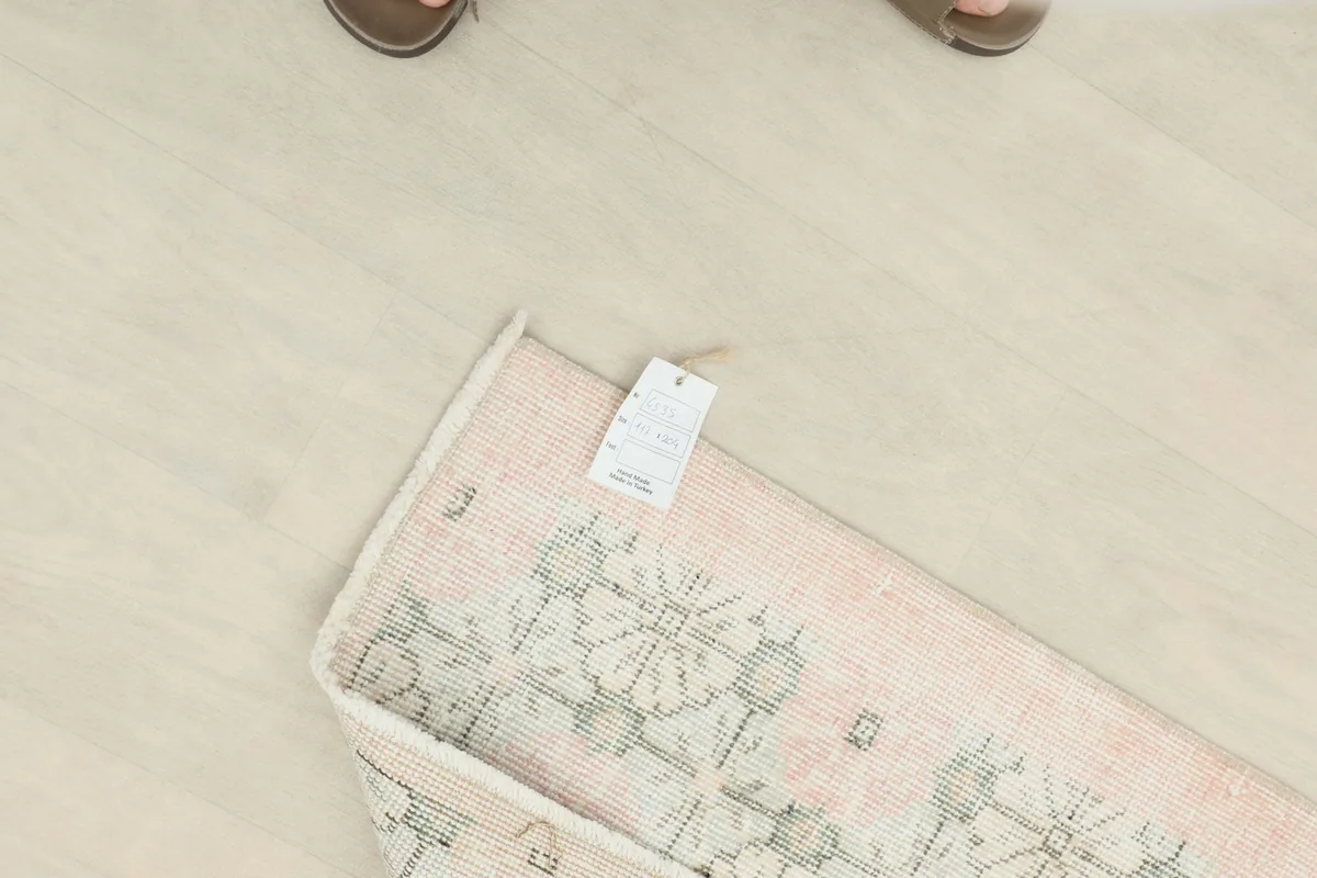 Overhead view of the rug with a tag, showing the texture and the professionally cleaned condition