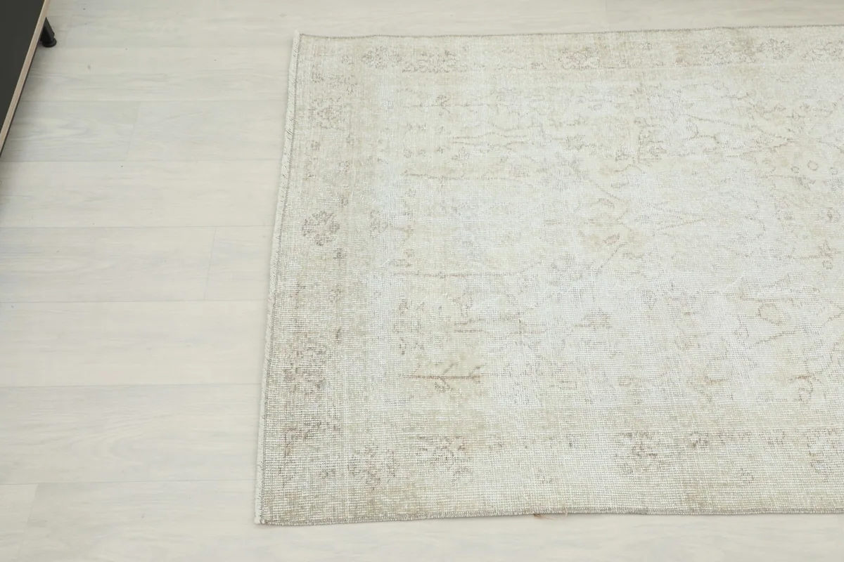 Detailed view of another corner of the rug, showing the subtle tan patterns and distressed texture