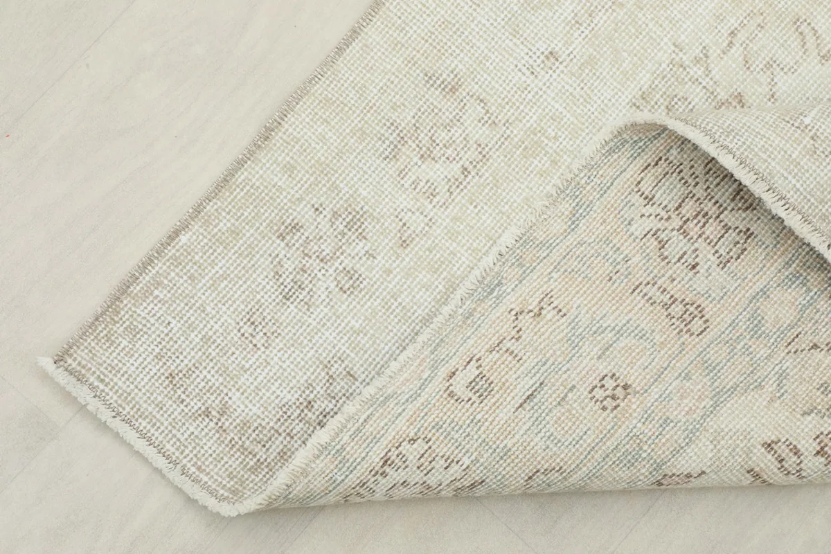 View of the rug's reverse side, revealing the cotton foundation and hand-knotted construction
