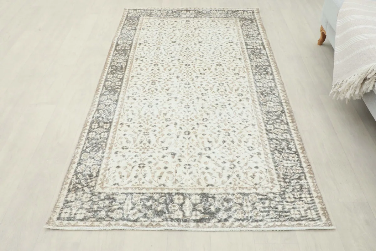 Full overhead view of the ivory and gray vintage Anatolian rug in a room setting, showing its complete design.
