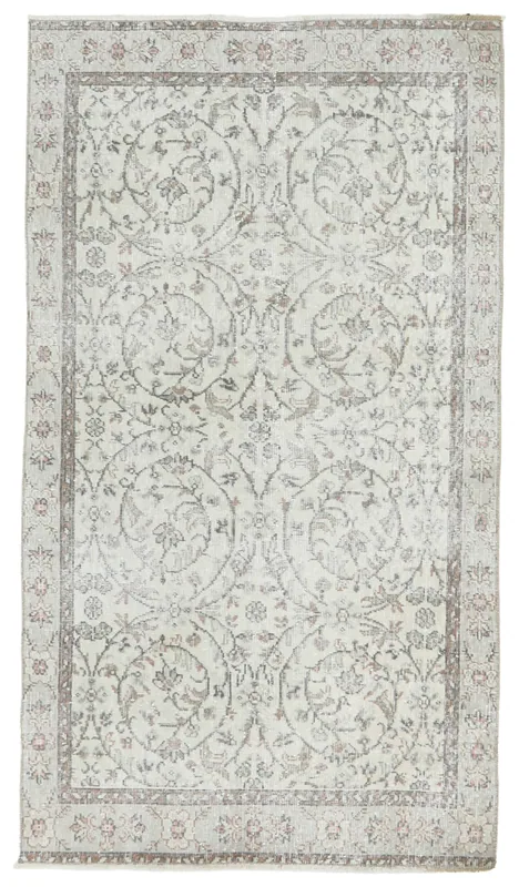Full top view of the ivory floral Anatolian vintage rug on a white background