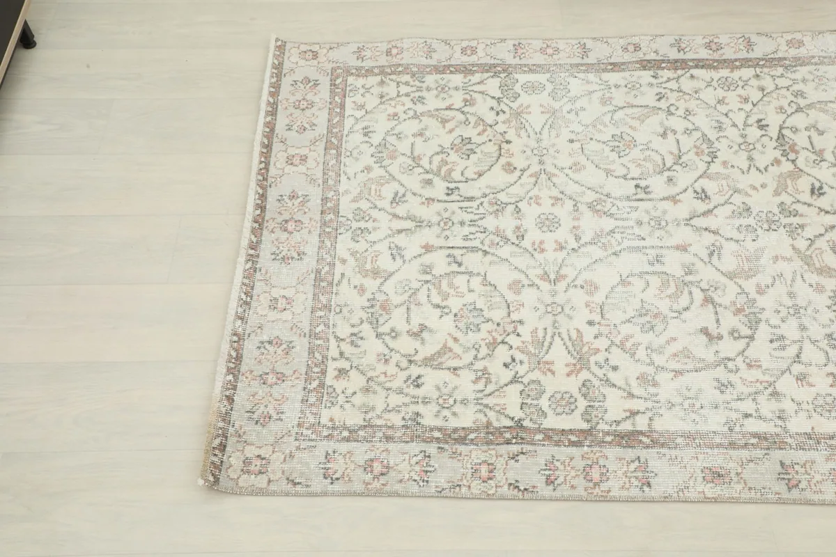 Angled shot of the vintage Anatolian rug, showcasing its rectangular shape and design