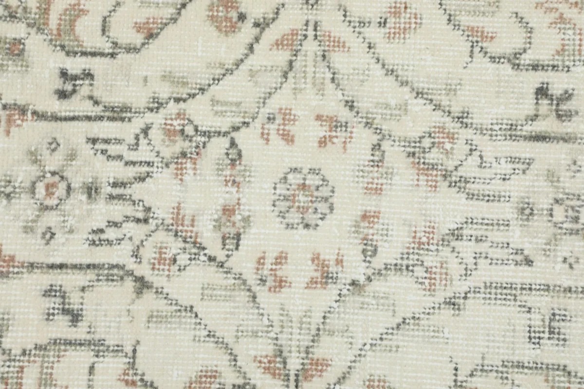 Close-up of the distressed wool pile, revealing the intricate knotting and color variations