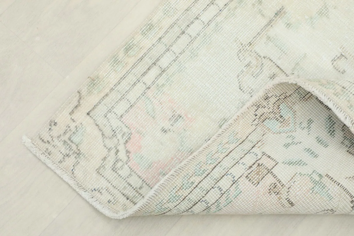 View of the back of the rug, showing the hand-knotted construction and cotton foundation