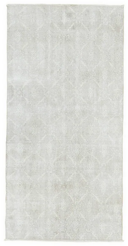 Full overhead view of the ivory geometric vintage area rug on a white background