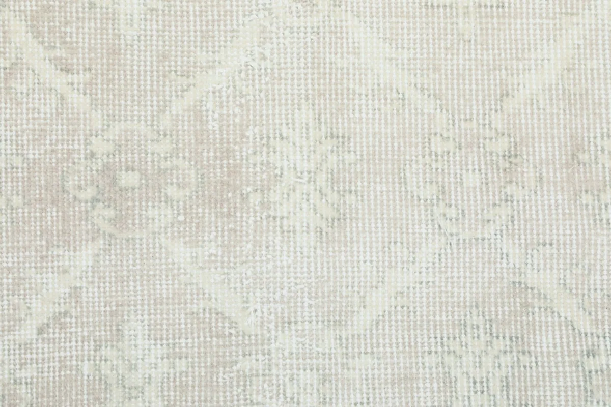 Detailed view of the low wool pile and the faded effect of the vintage rug