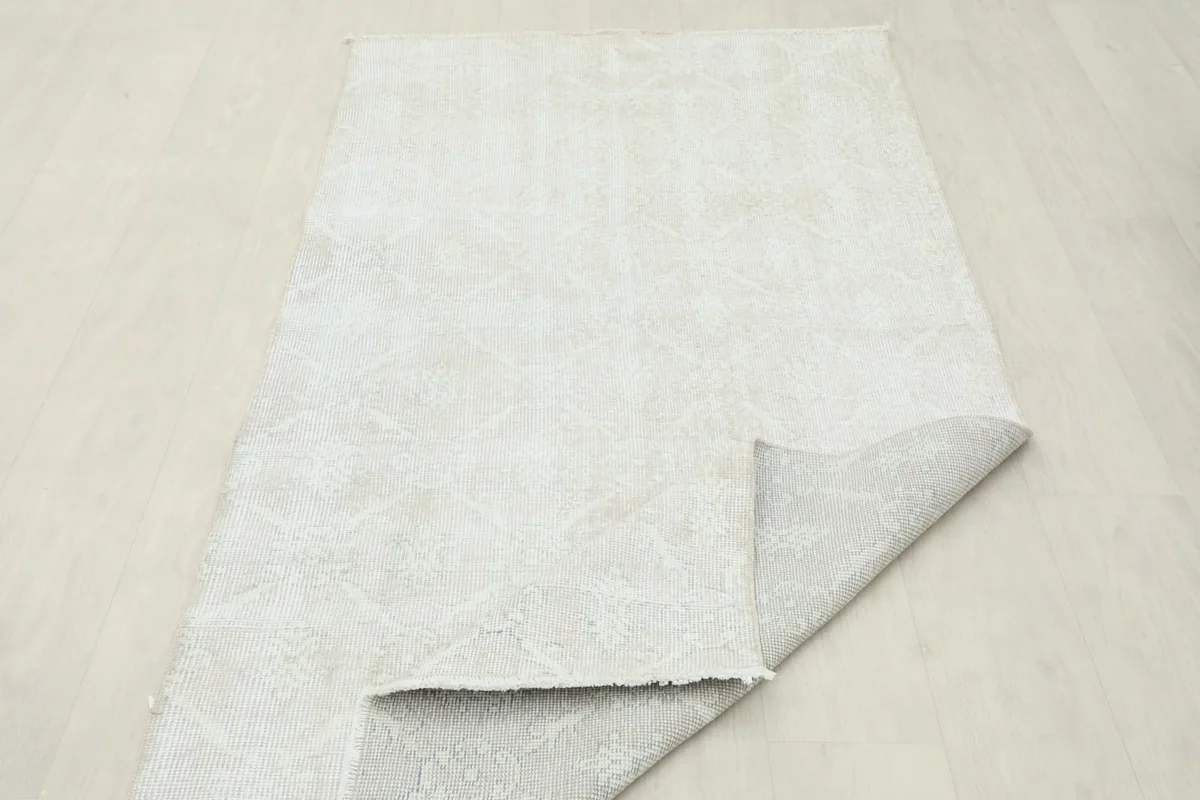 View of the rug's underside, revealing the cotton foundation and hand-knotted construction