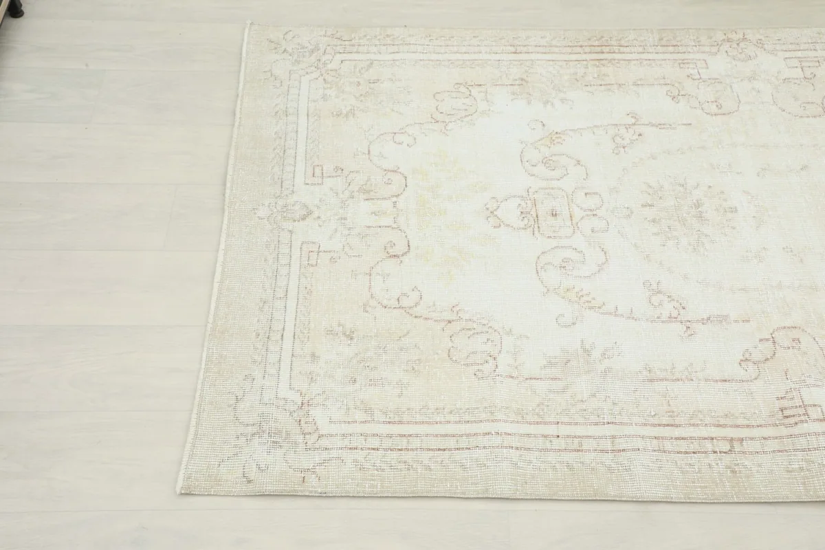 Another angle view of the rug's border and field, revealing subtle color variations